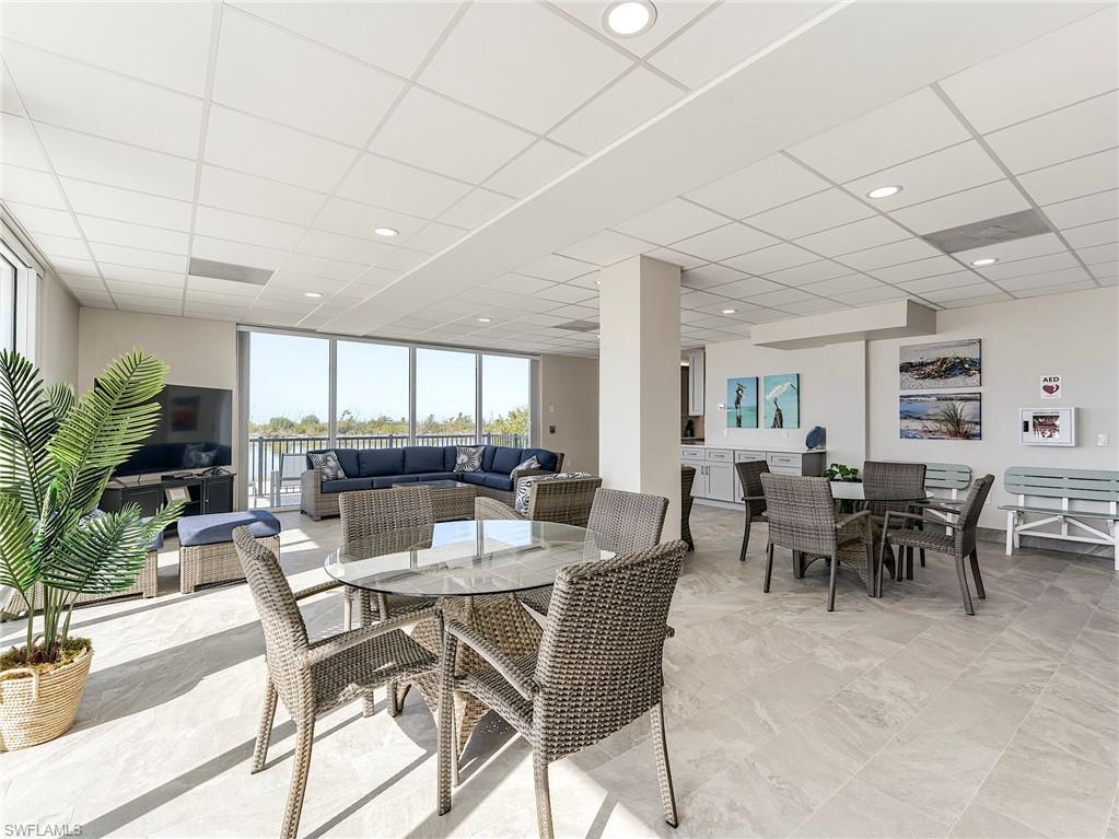 Community room featuring floor to ceiling impact glass sliders to beachside patio and heated pool with spacious sundeck all overlooking the sand and sparkling gulf waters