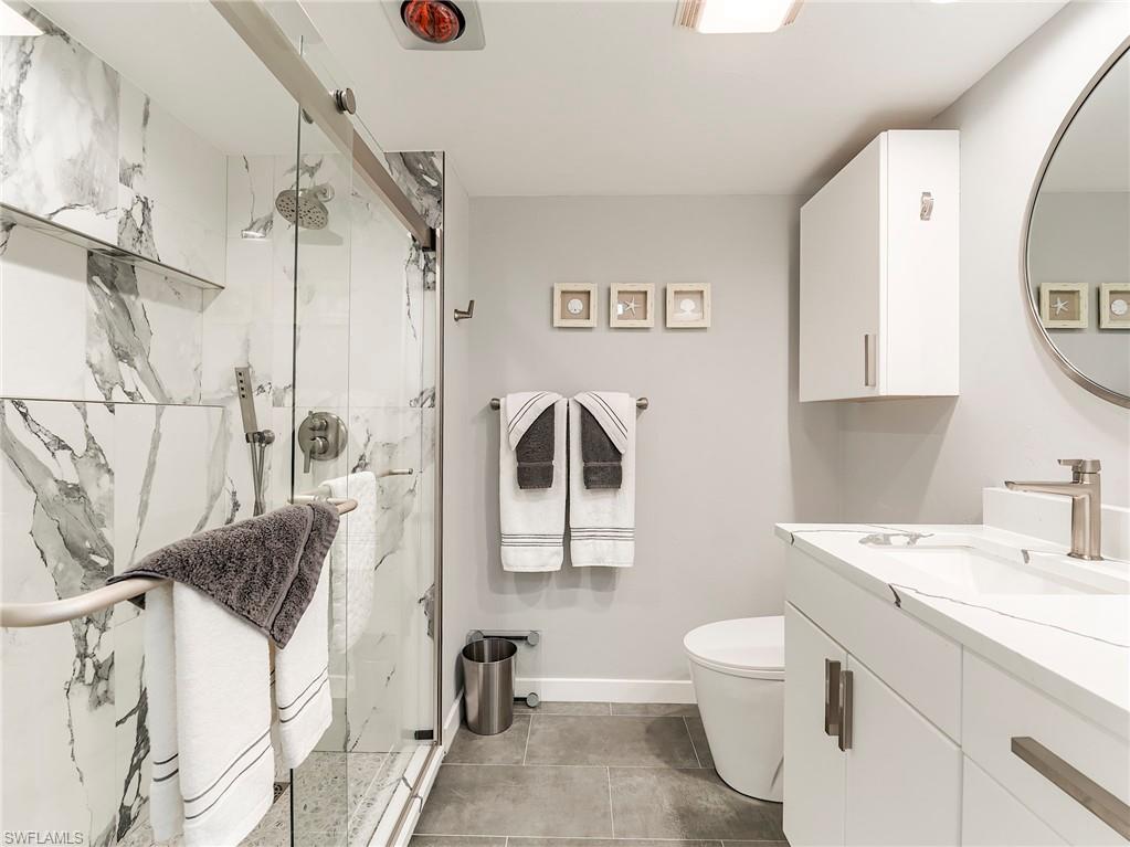 Full bathroom with vanity and a marble finish shower
