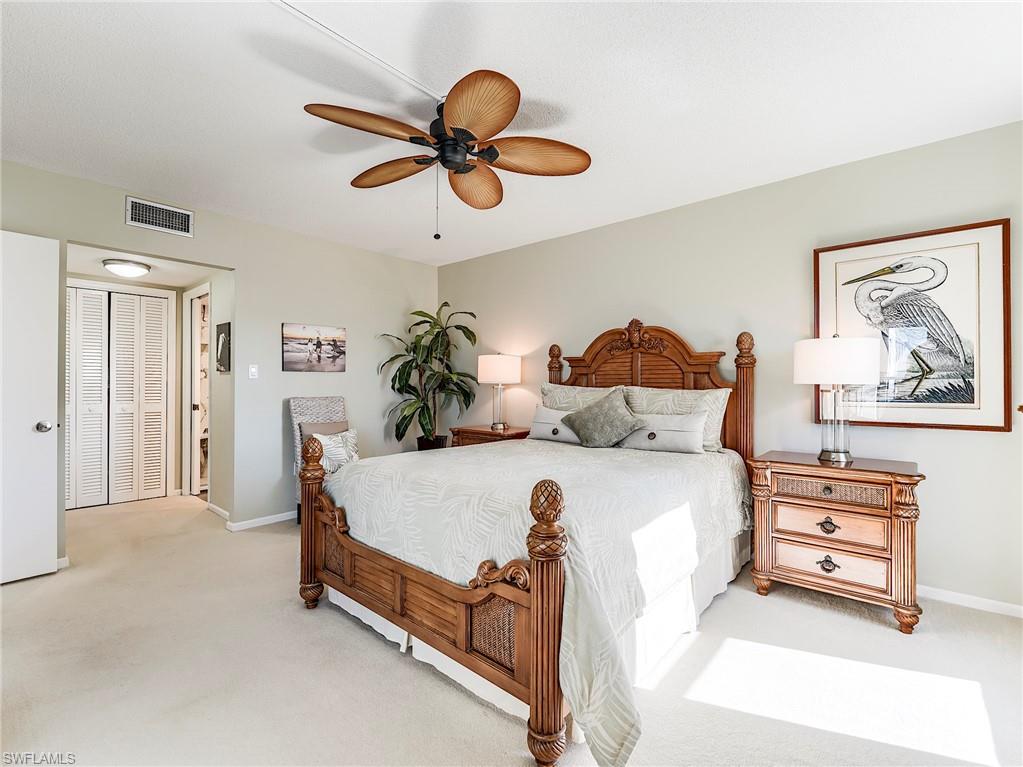 Carpeted bedroom featuring ceiling fan and baseboards