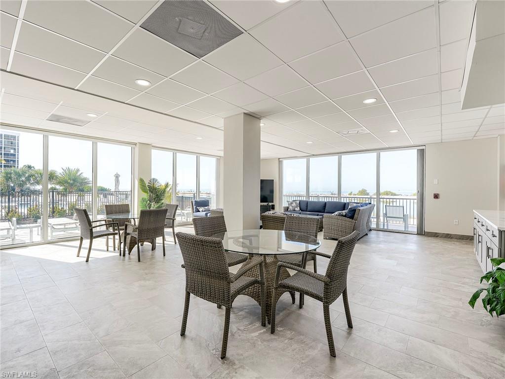 Dining room with expansive windows, a drop ceiling, and recessed lighting