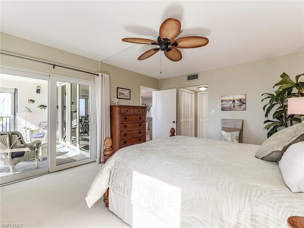 Bedroom with carpet floors, access to outside, a closet, and a ceiling fan