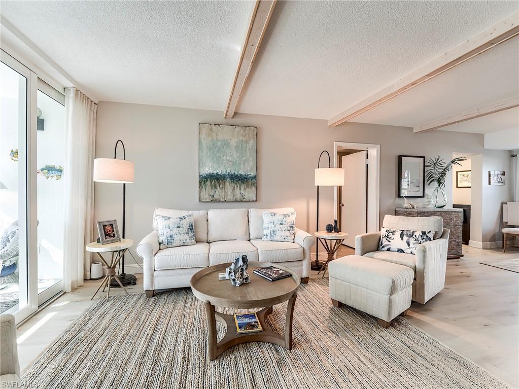Living area with beam ceiling and a textured ceiling
