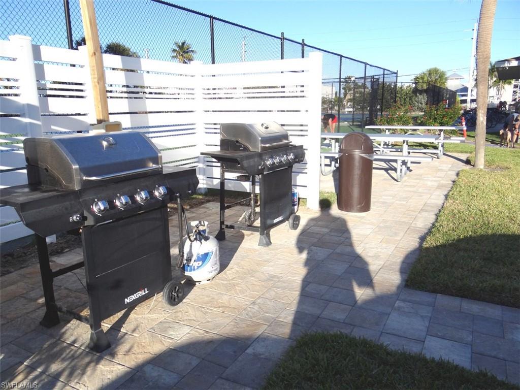 View of patio with a grill
