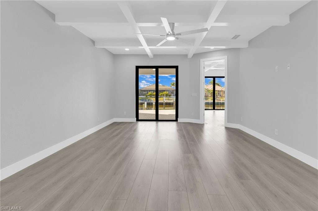 Unfurnished room with coffered ceiling, beamed ceiling, light wood-style floors, recessed lighting, and a ceiling fan