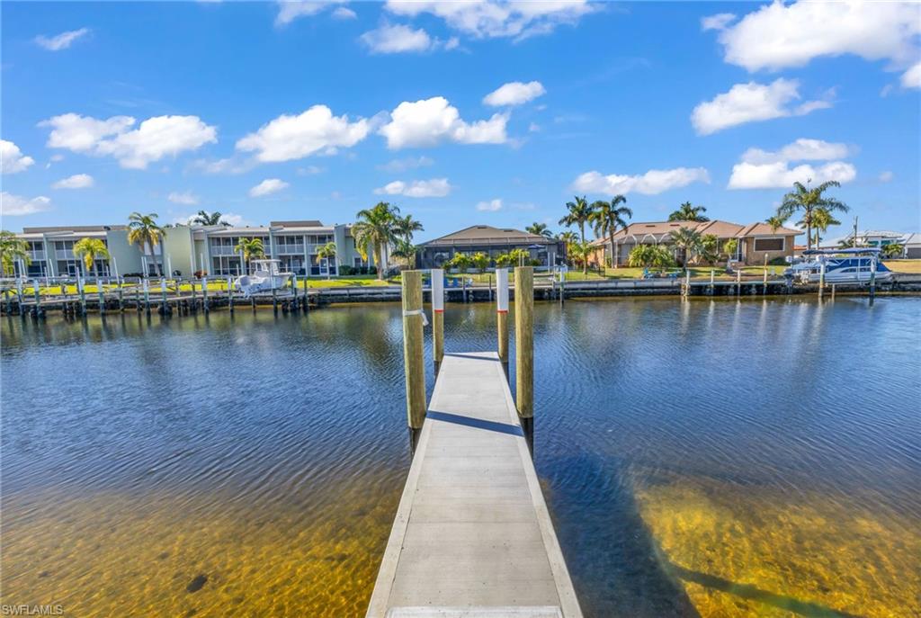 Dock featuring a residential view and a water view