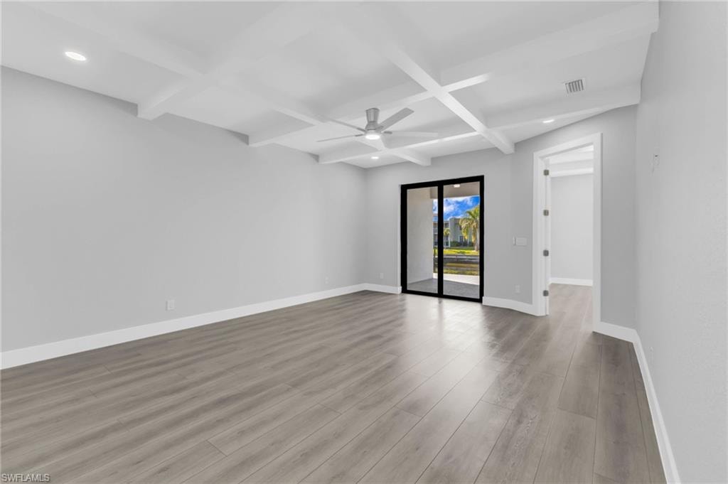Unfurnished room featuring coffered ceiling, beam ceiling, light wood finished floors, ceiling fan, and recessed lighting