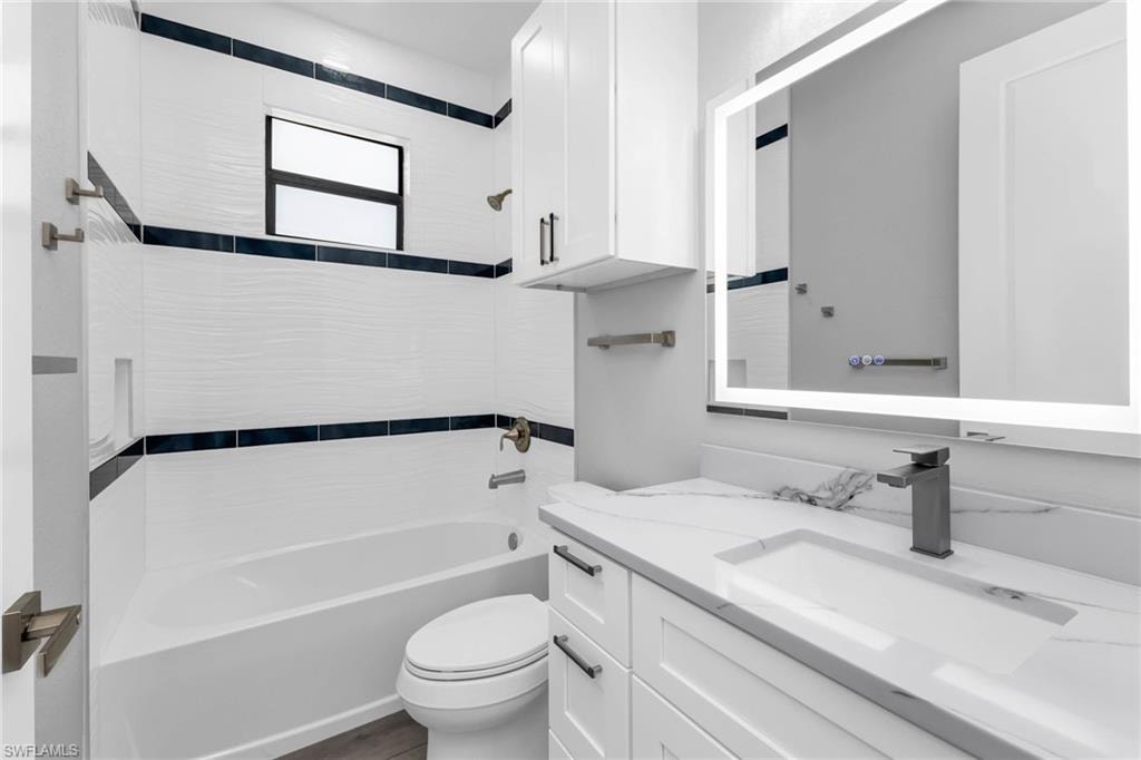 Bathroom featuring  shower combination and vanity
