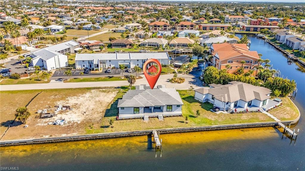 Aerial view of residential area featuring a nearby body of water