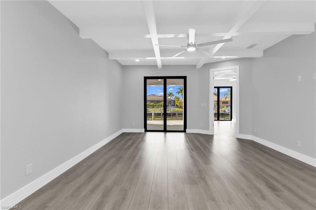 Unfurnished room with beam ceiling, light wood finished floors, a ceiling fan, and recessed lighting