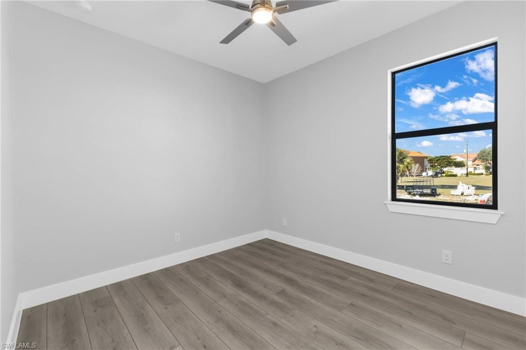 Unfurnished room with wood finished floors and ceiling fan