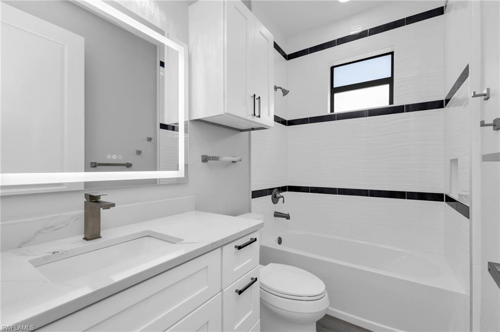 Bathroom featuring  shower combination and vanity