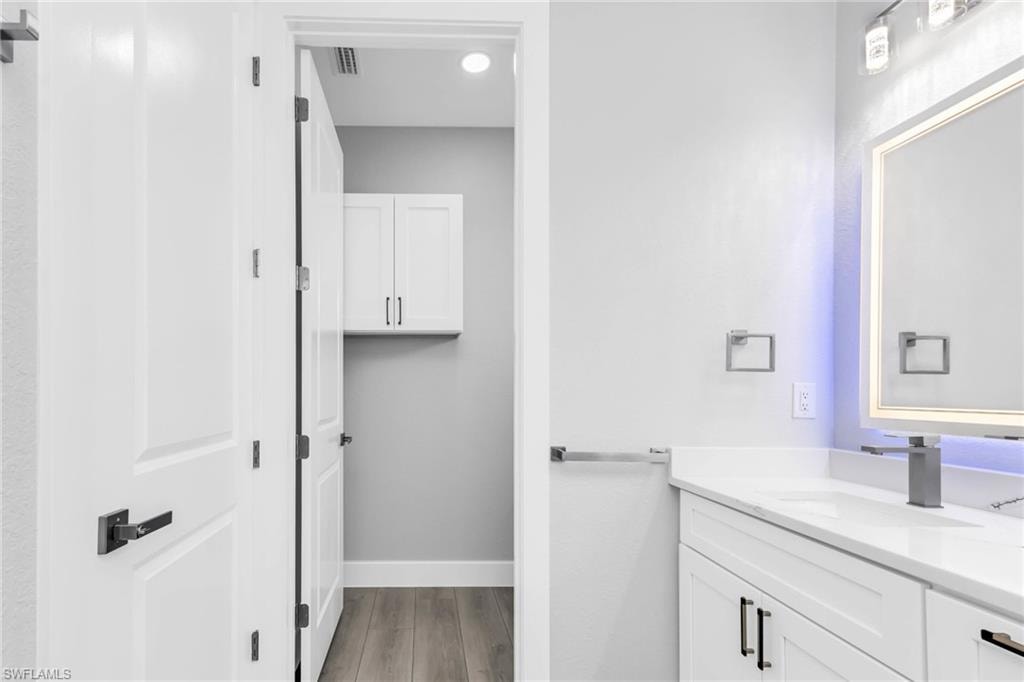 Bathroom featuring vanity and light wood-style flooring