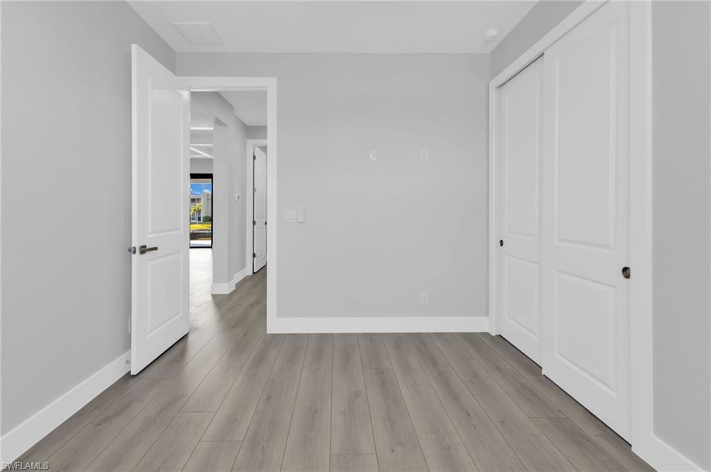 Unfurnished bedroom with a closet and light wood-style floors