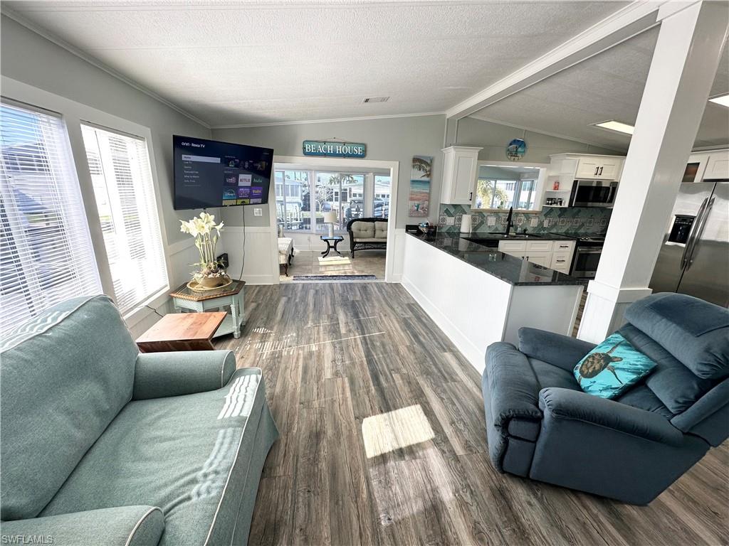 Living area adjacent to kitchen and dining.