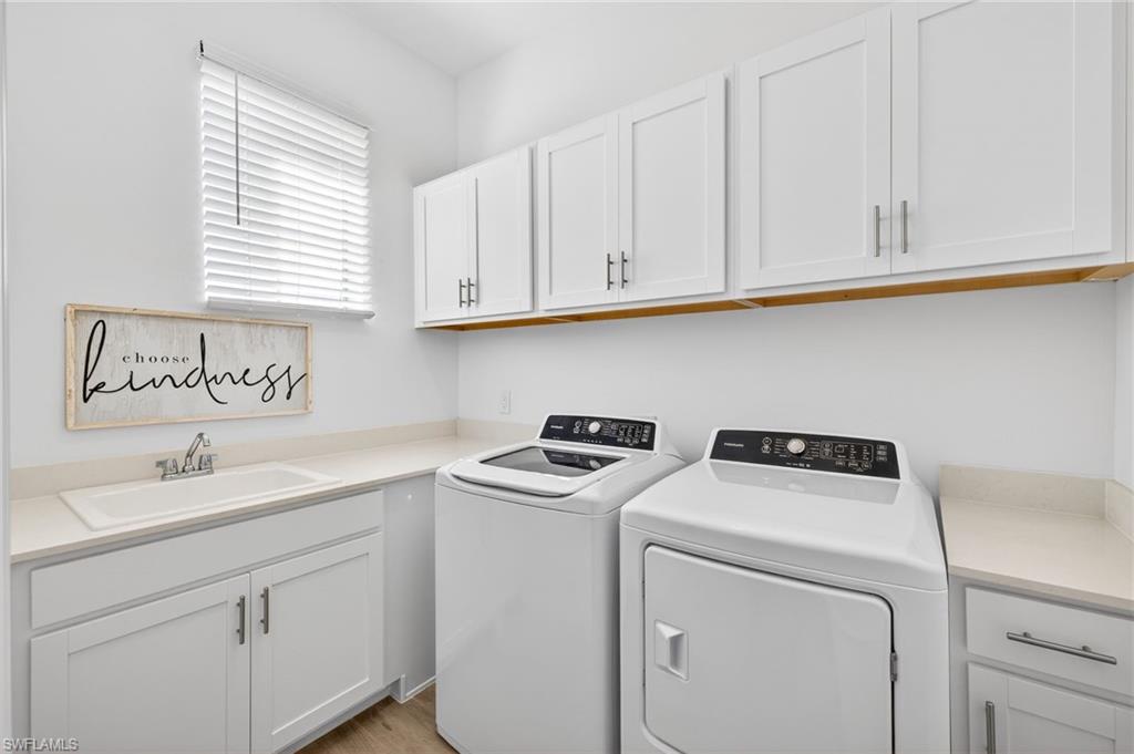 Washroom with cabinet space and independent washer and dryer