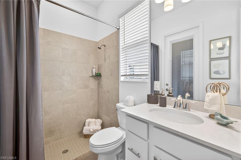 Full bath with a shower stall and vanity