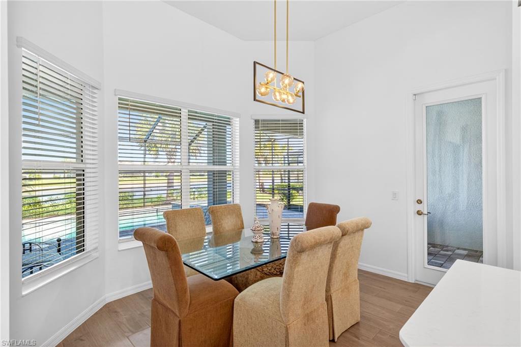 Dining room with wood finished floors and a chandelier