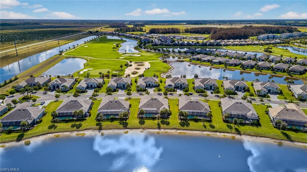 Aerial view of residential area featuring a nearby body of water