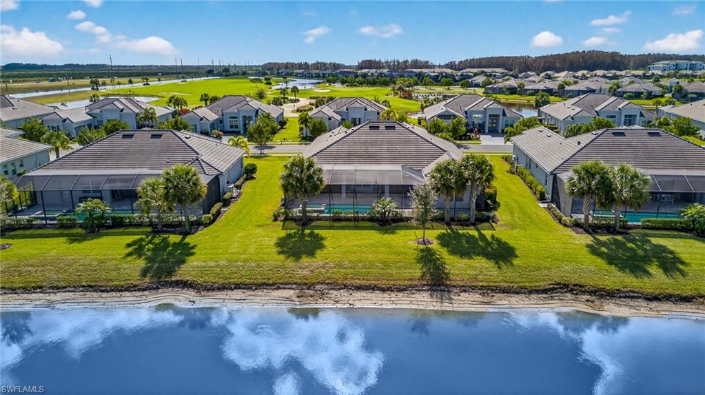 Aerial perspective of suburban area with a nearby body of water