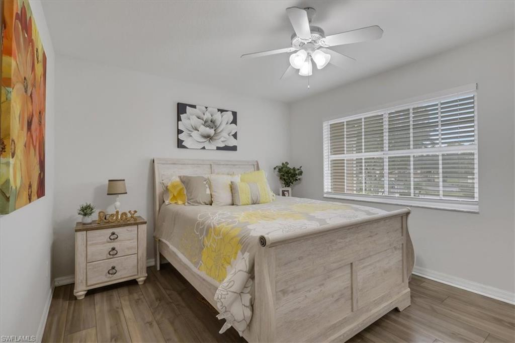 Bedroom 2with a ceiling fan and a shelved walk-in closet