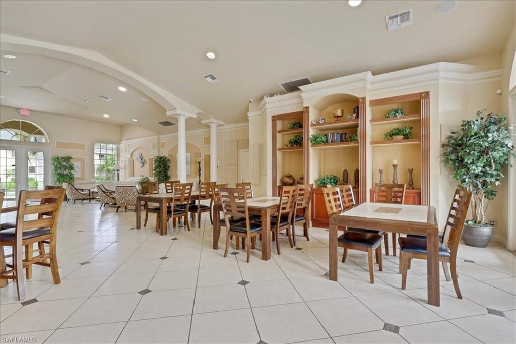 Game and card playing  space with ornate columns, light tile patterned floors, recessed lighting, french doors, and arched walkways