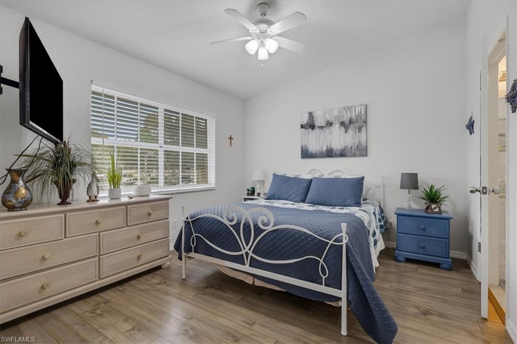 Bedroom 3with light wood finished floors, ceiling fan, and lofted ceiling