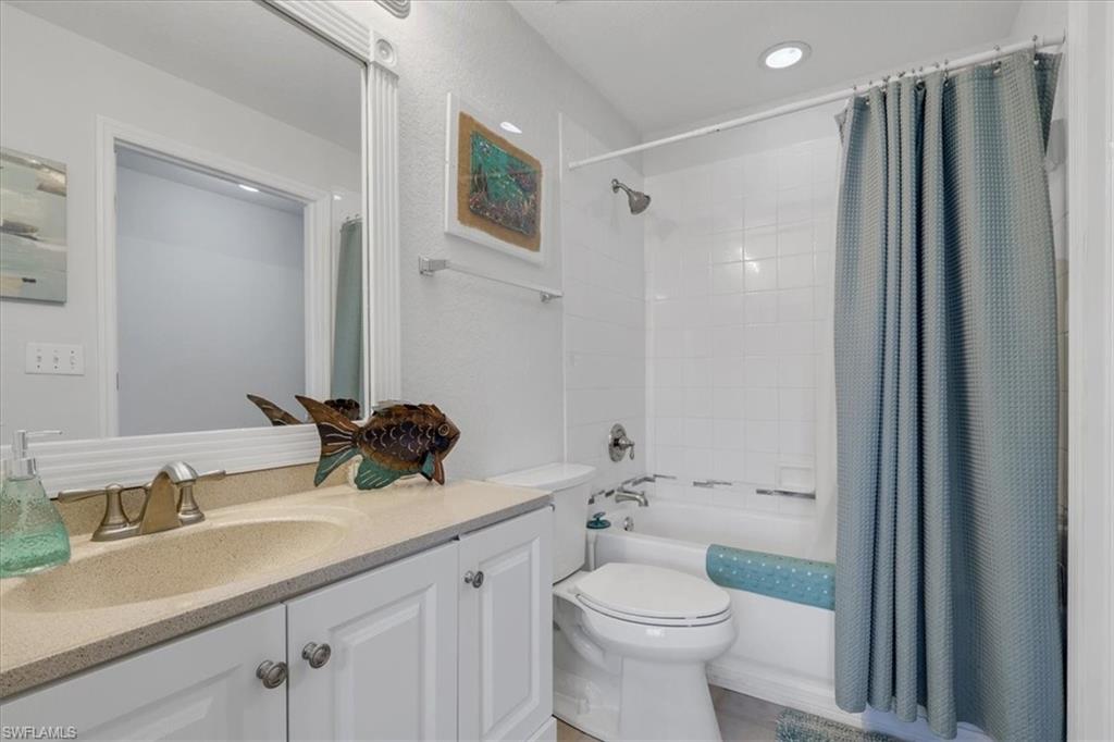 Full 2nd bathroom featuring shower / tub combo with curtain, vanity, and recessed lighting