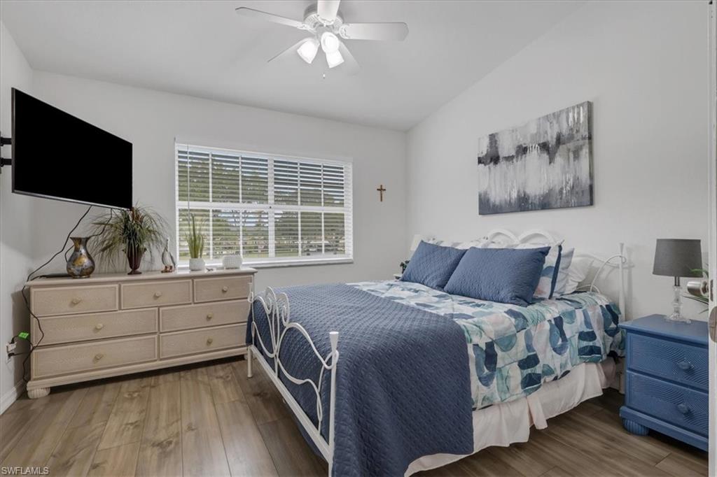 Bedroom 3with light wood finished floors, ceiling fan, and lofted ceiling