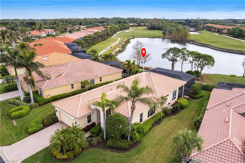 Aerial perspective of suburban area with a large body of water and a golf club