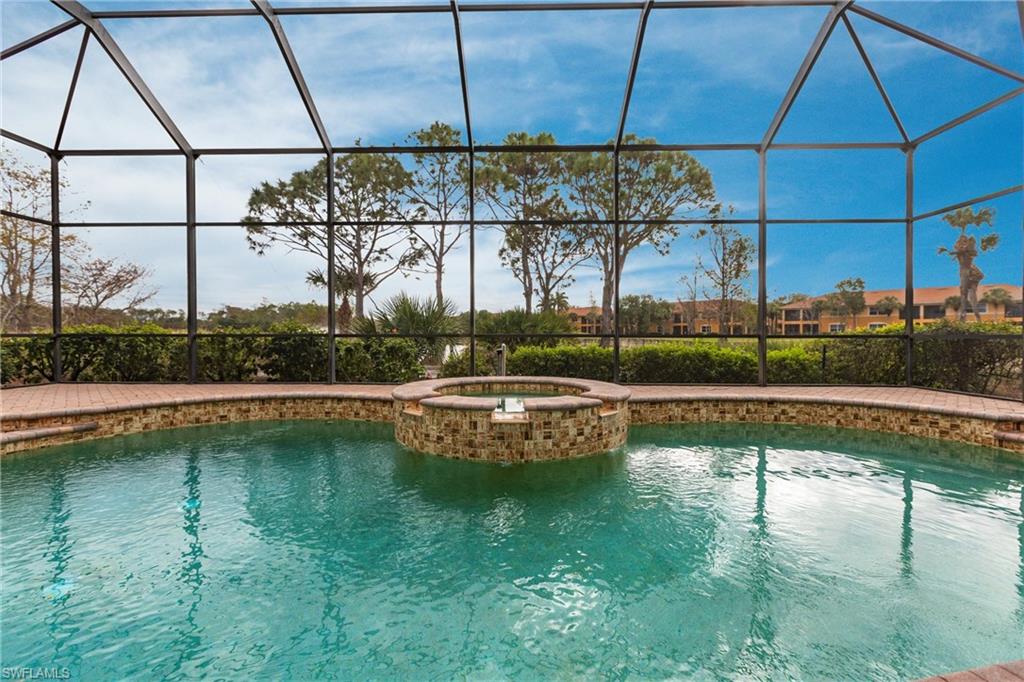 View of pool with a sunroom, a lanai, and a pool with connected hot tub