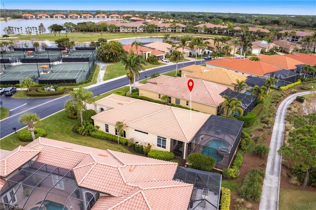 Aerial perspective of suburban area featuring a nearby body of water