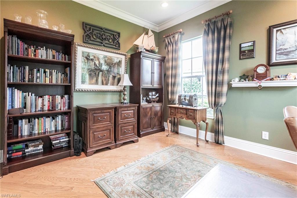 Office area featuring ornamental molding and light wood-style flooring