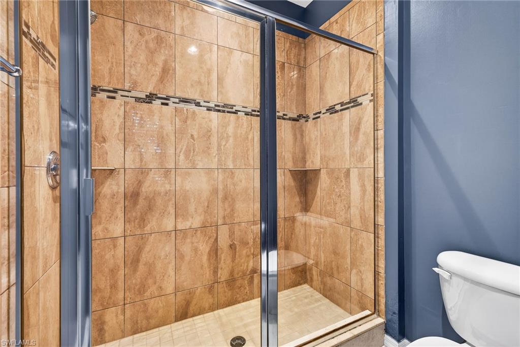Bathroom with a stall shower and toilet