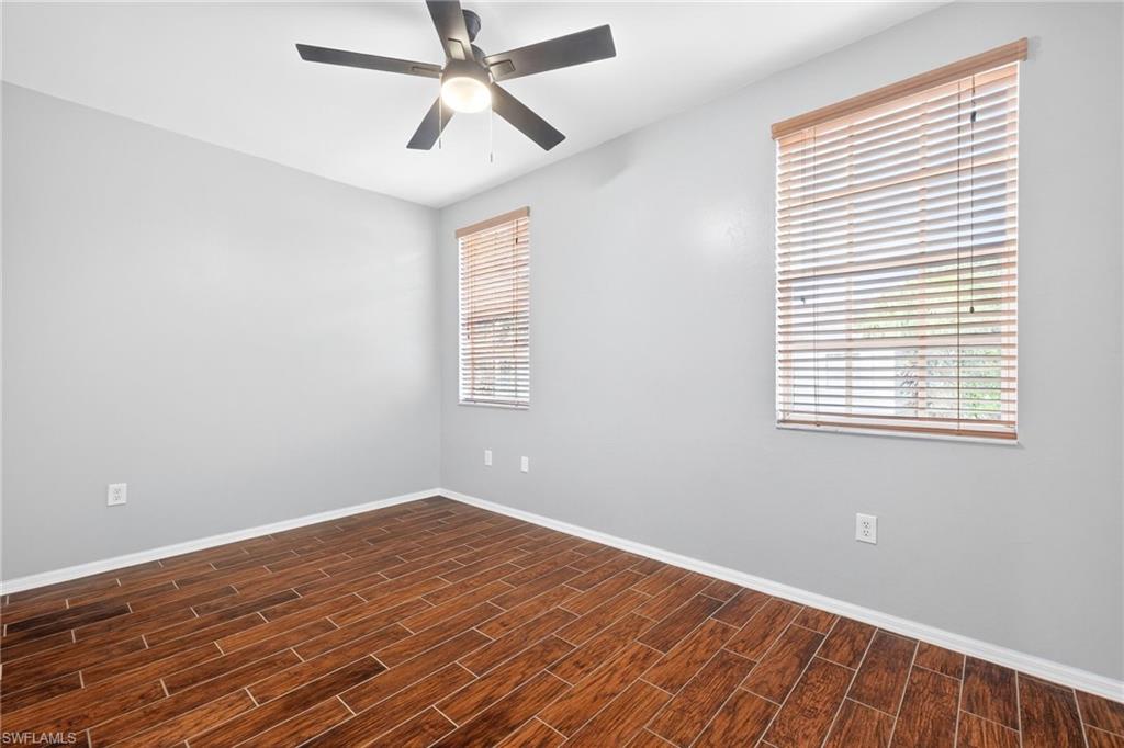 Spare room featuring wood tiled floors and a ceiling fan