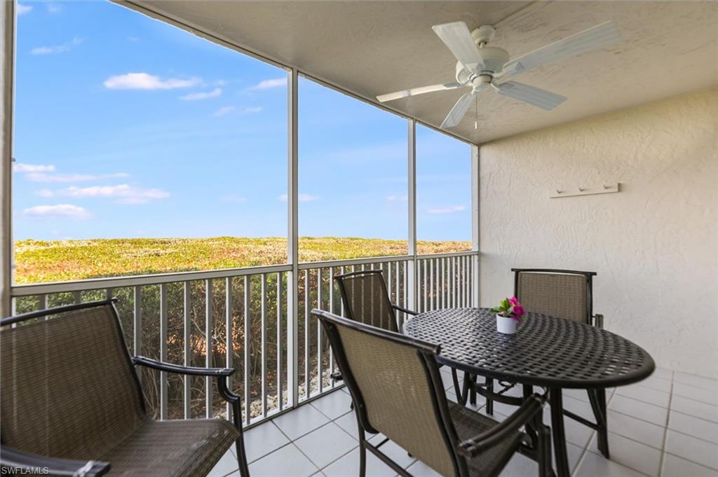 Sunroom featuring a balcony and ceiling fan