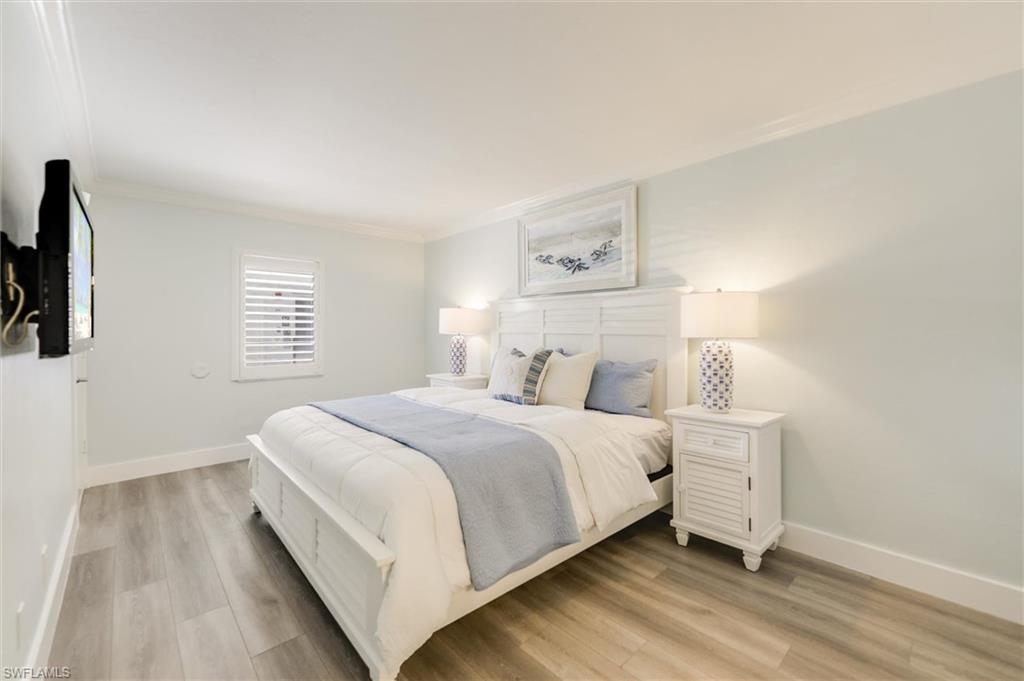 Bedroom featuring crown molding and light wood finished floors
