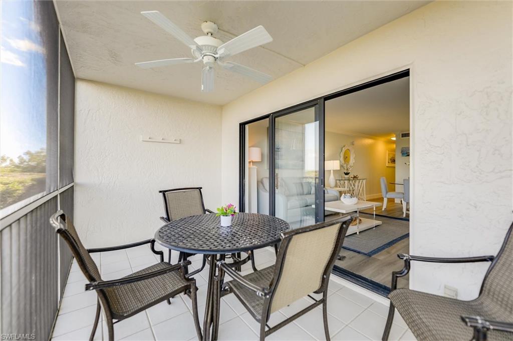 Sunroom featuring a ceiling fan