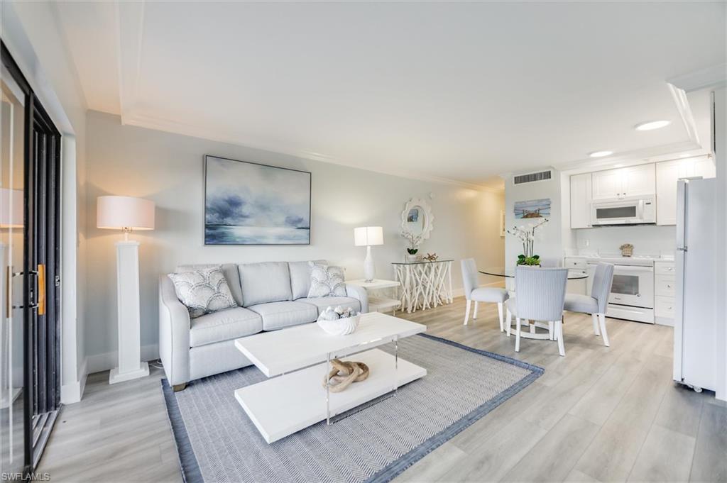 Living room featuring crown molding, light wood-style floors, and recessed lighting