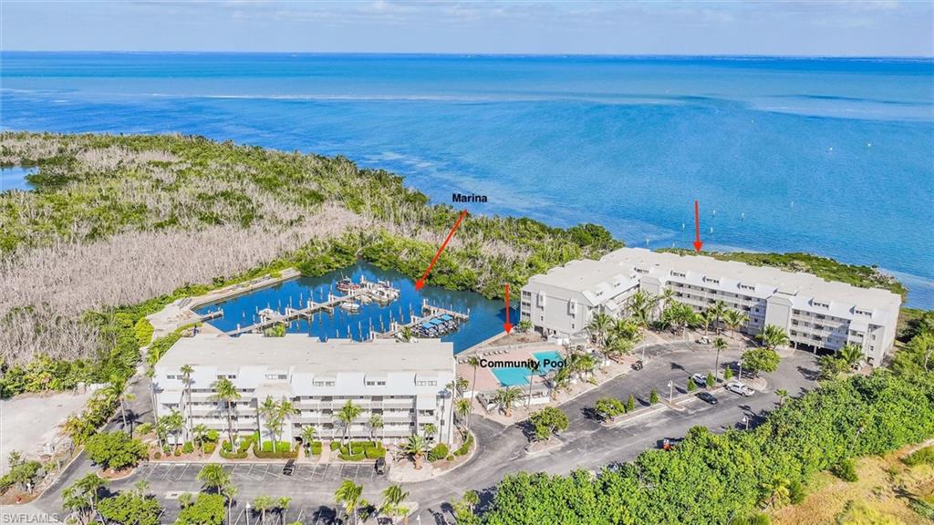 Drone / aerial view of a nearby body of water and a marina