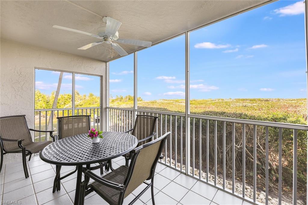 Sunroom / solarium with a ceiling fan, outdoor dining area, and a balcony