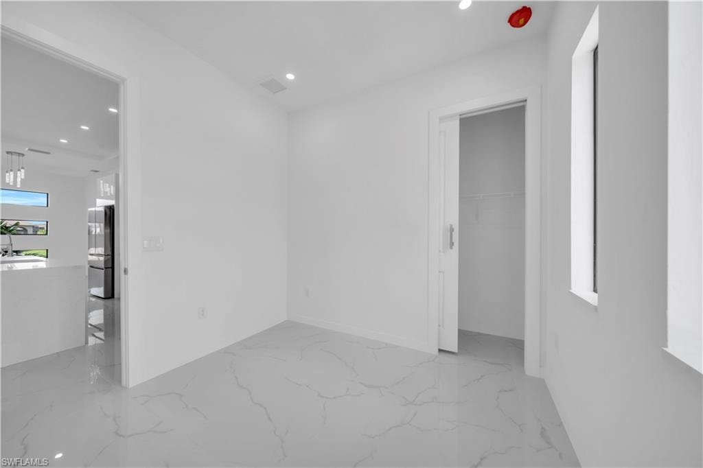 Spare room with recessed lighting and light marble finish flooring