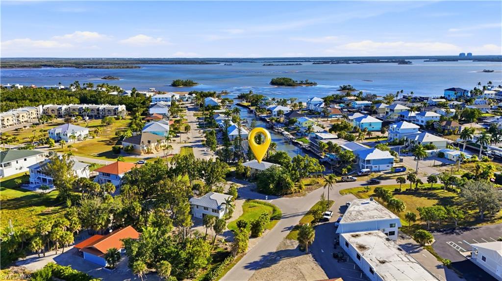 Aerial overview of property's location with nearby suburban area and a large body of water