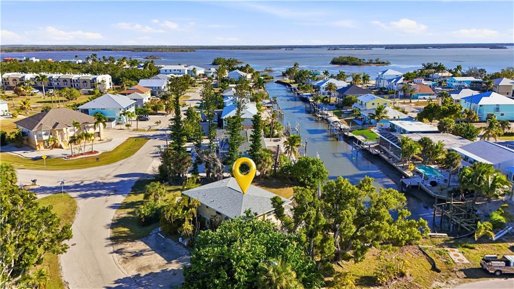 Aerial view of residential area featuring a nearby body of water - Virtually Edited Image