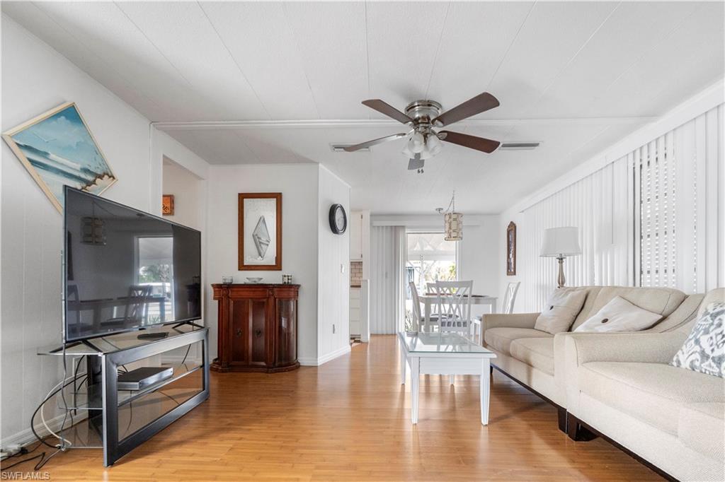 Living room featuring light wood finished floors and ceiling fan