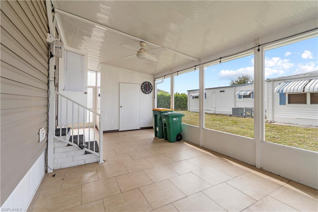 Unfurnished sunroom featuring a ceiling fan