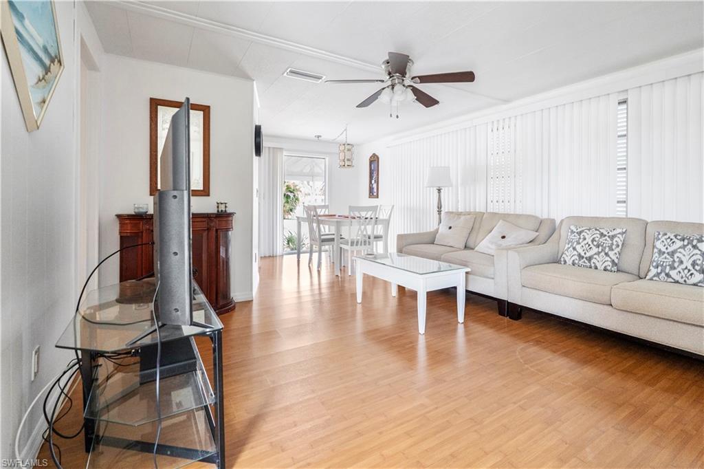 Living room with light wood-style floors and a ceiling fan