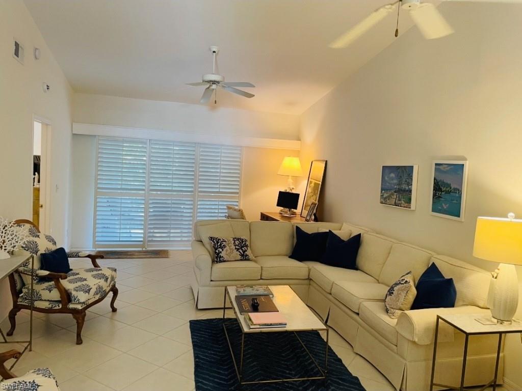 Living area with a ceiling fan and lofted ceiling