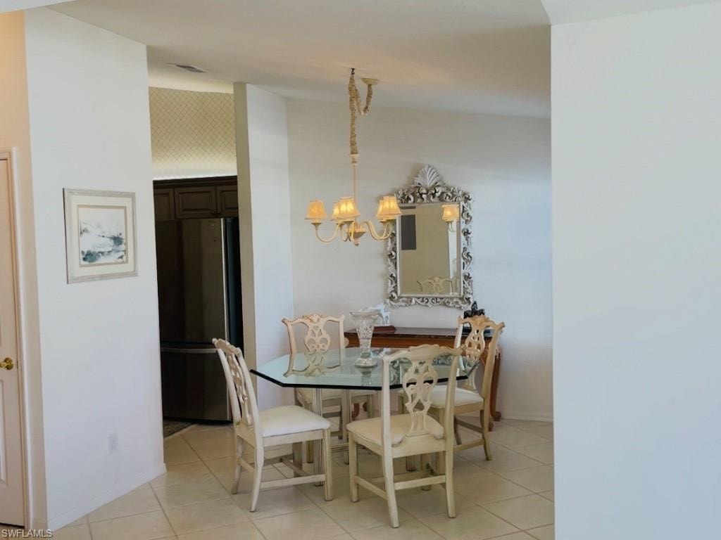 Dining room featuring light tile patterned floors and hanging lights