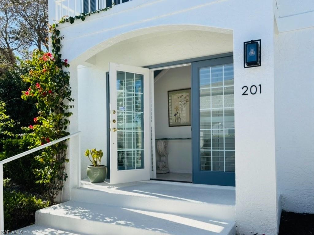 View of exterior entry featuring stucco siding
