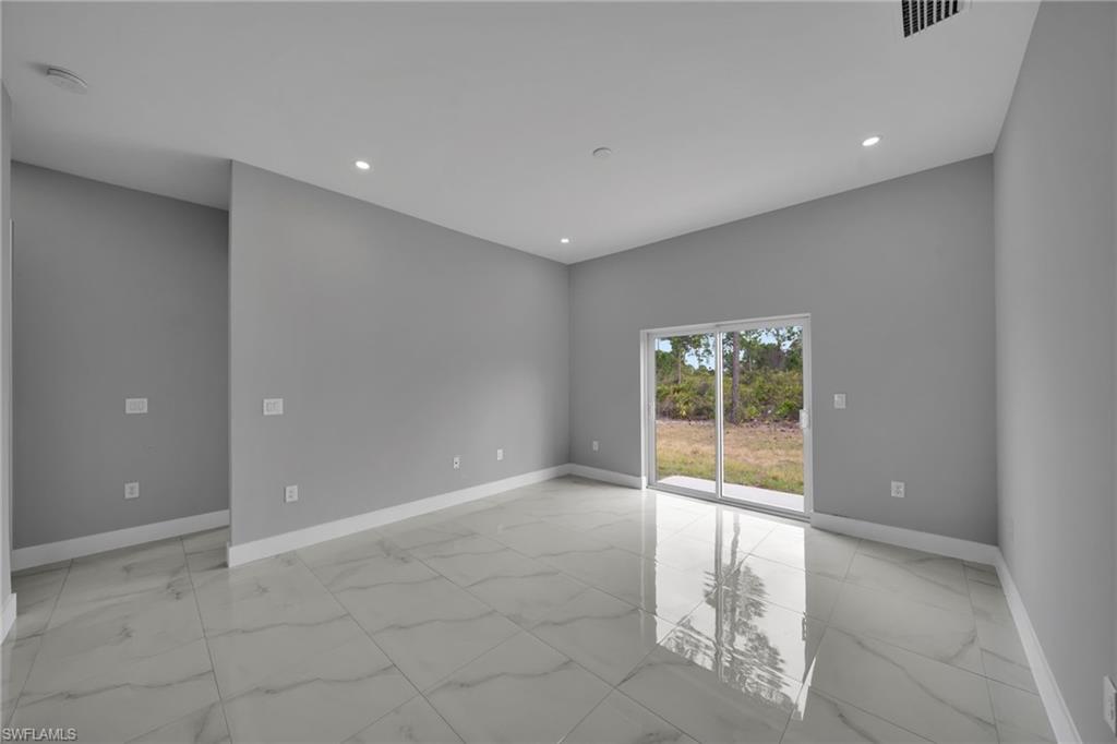 Spare room with light marble finish flooring and recessed lighting